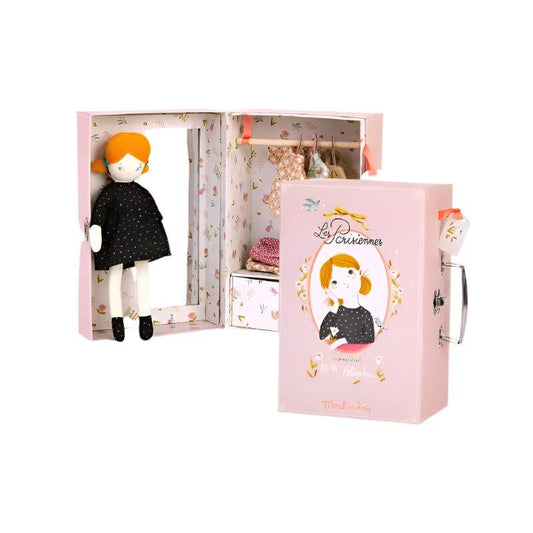 Doll with red hair and black outfit in a pink box with 'La Perruchette' branding.