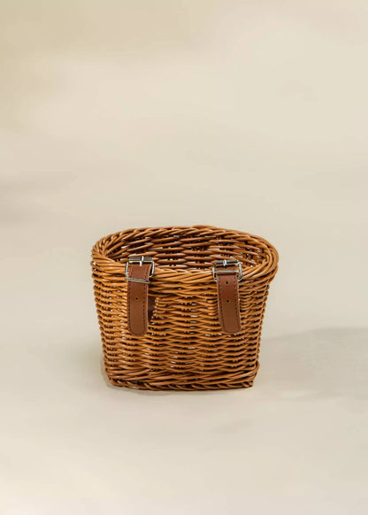 Bike basket filled with toys on a balance bike