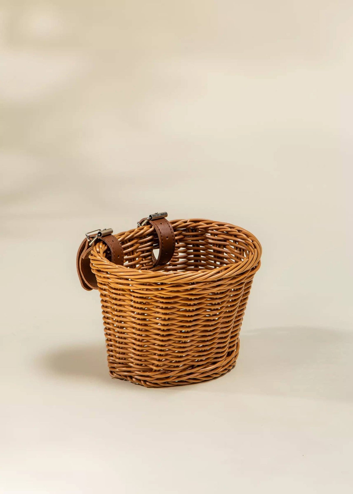 Woven bike basket mounted on a balance bike handlebar