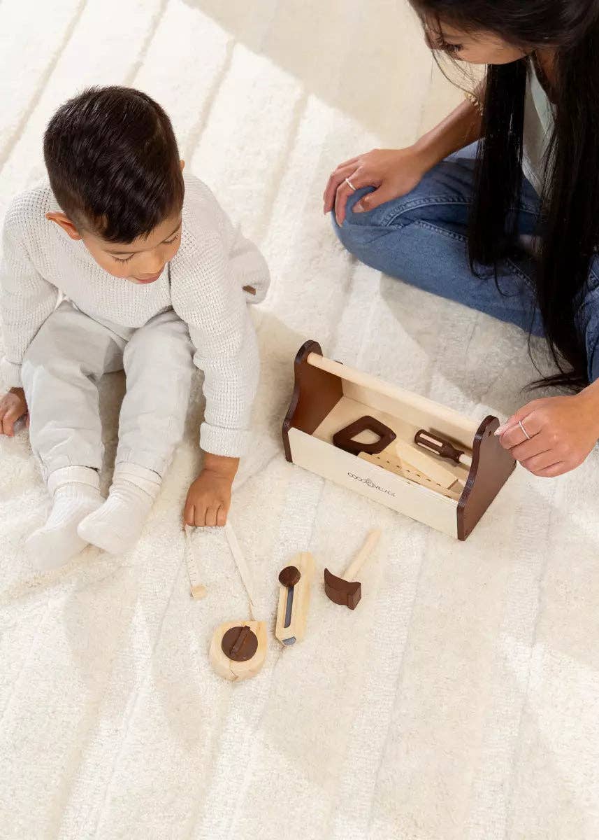 Wooden tool playset pieces laid out for imaginative play