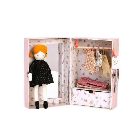Doll with orange hair and black dress in a pink wardrobe with clothes and accessories.