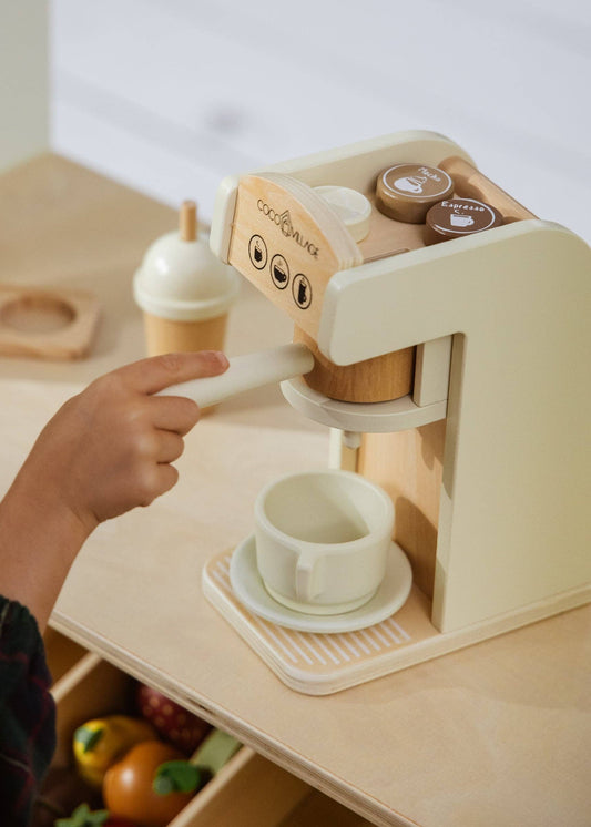 Child using wooden toy coffee maker - pretend play barista set