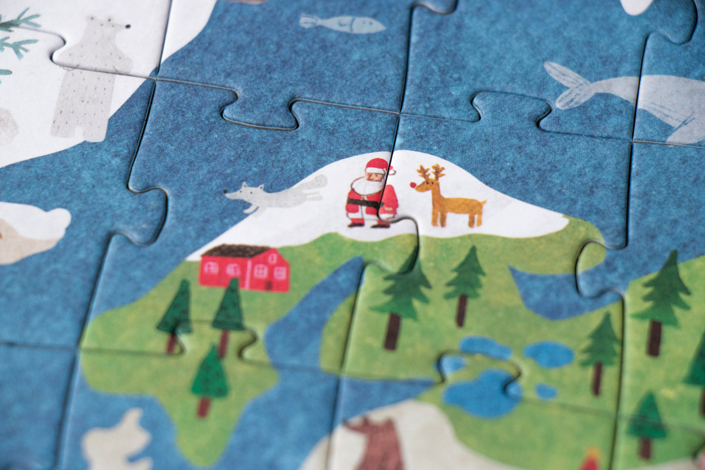 Children's puzzle with a Santa Claus and reindeer design on a blue background
