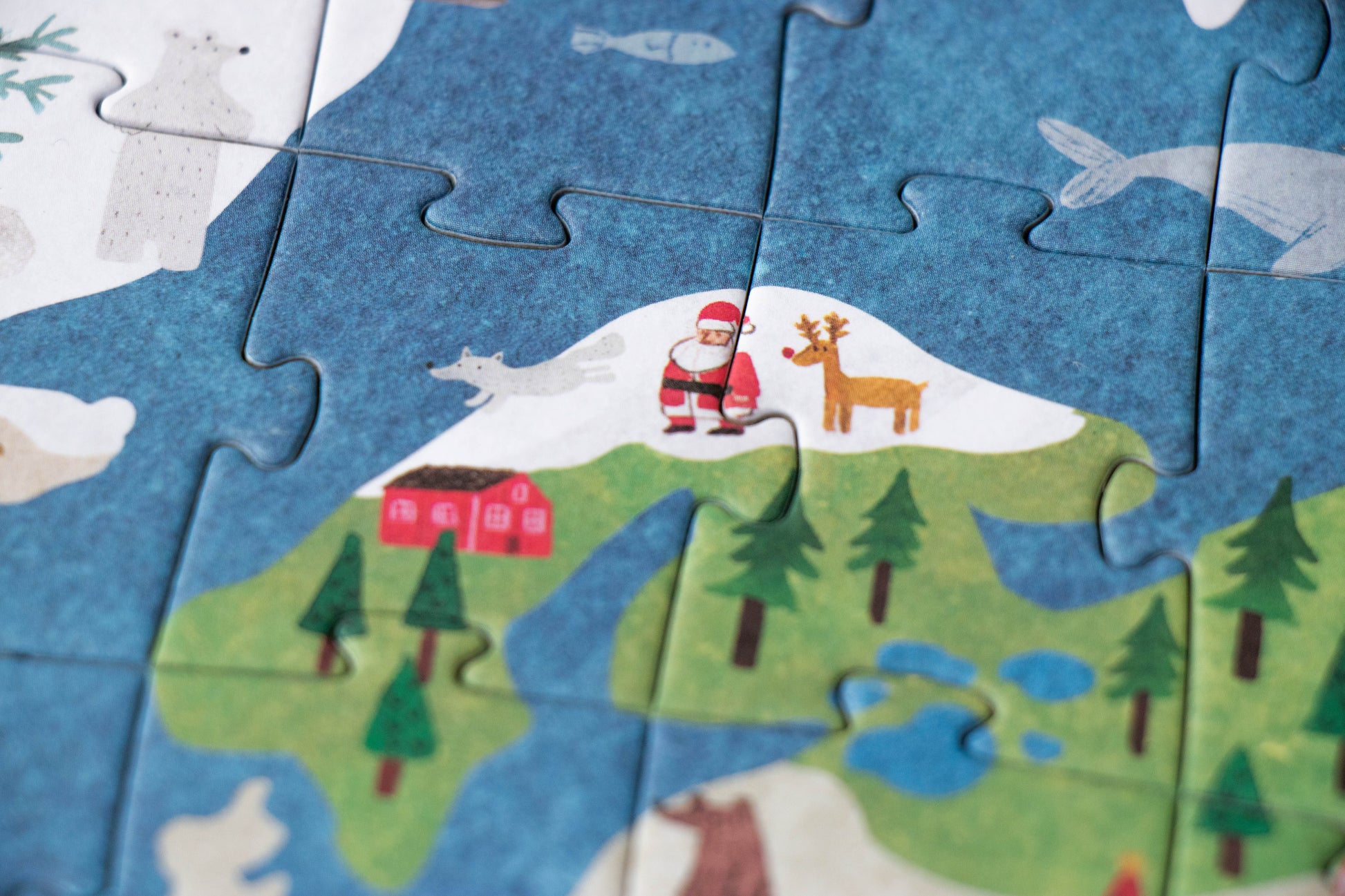 Children's puzzle with a Santa Claus and reindeer design on a blue background