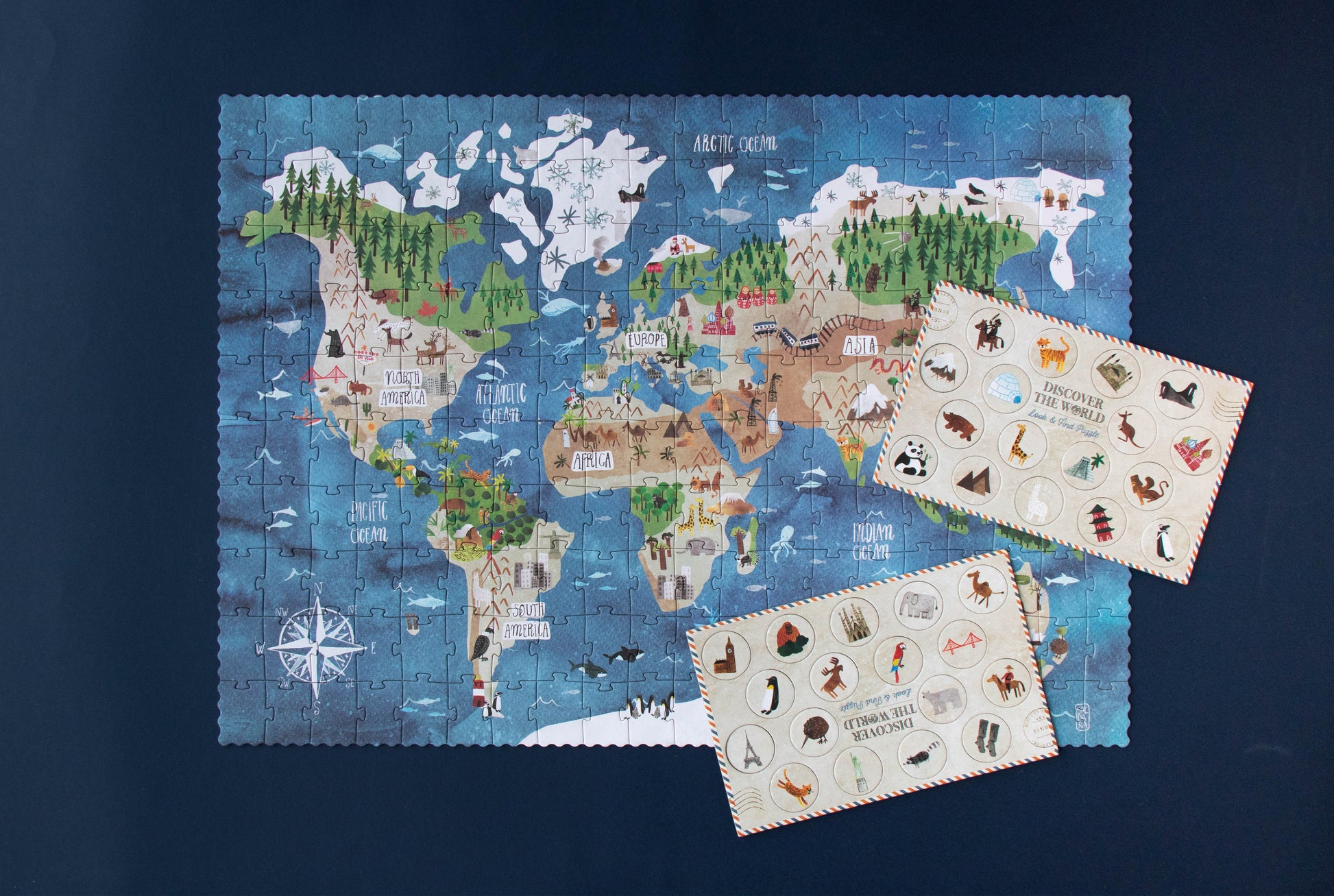 World map puzzle with animal illustrations on a dark blue background
