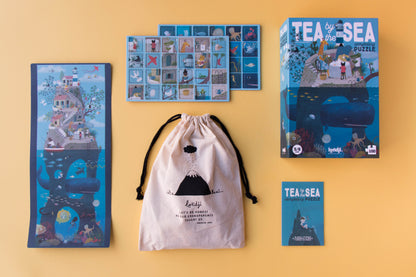 Tea by the Sea puzzle packaging and accessories on a yellow background