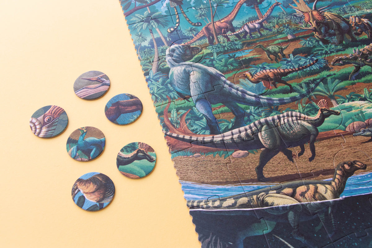 Dinosaur-themed board game pieces and packaging on a beige background