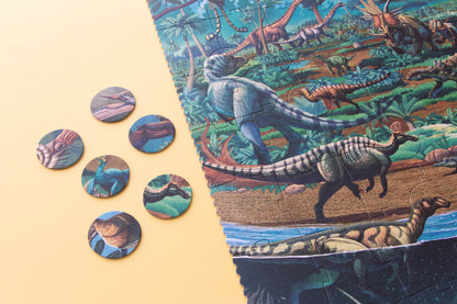 Dinosaur-themed board game pieces and packaging on a beige background