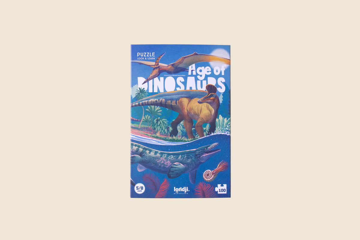 Londji Age of Dinosaurs jigsaw puzzle box with dinosaur artwork on a peach background