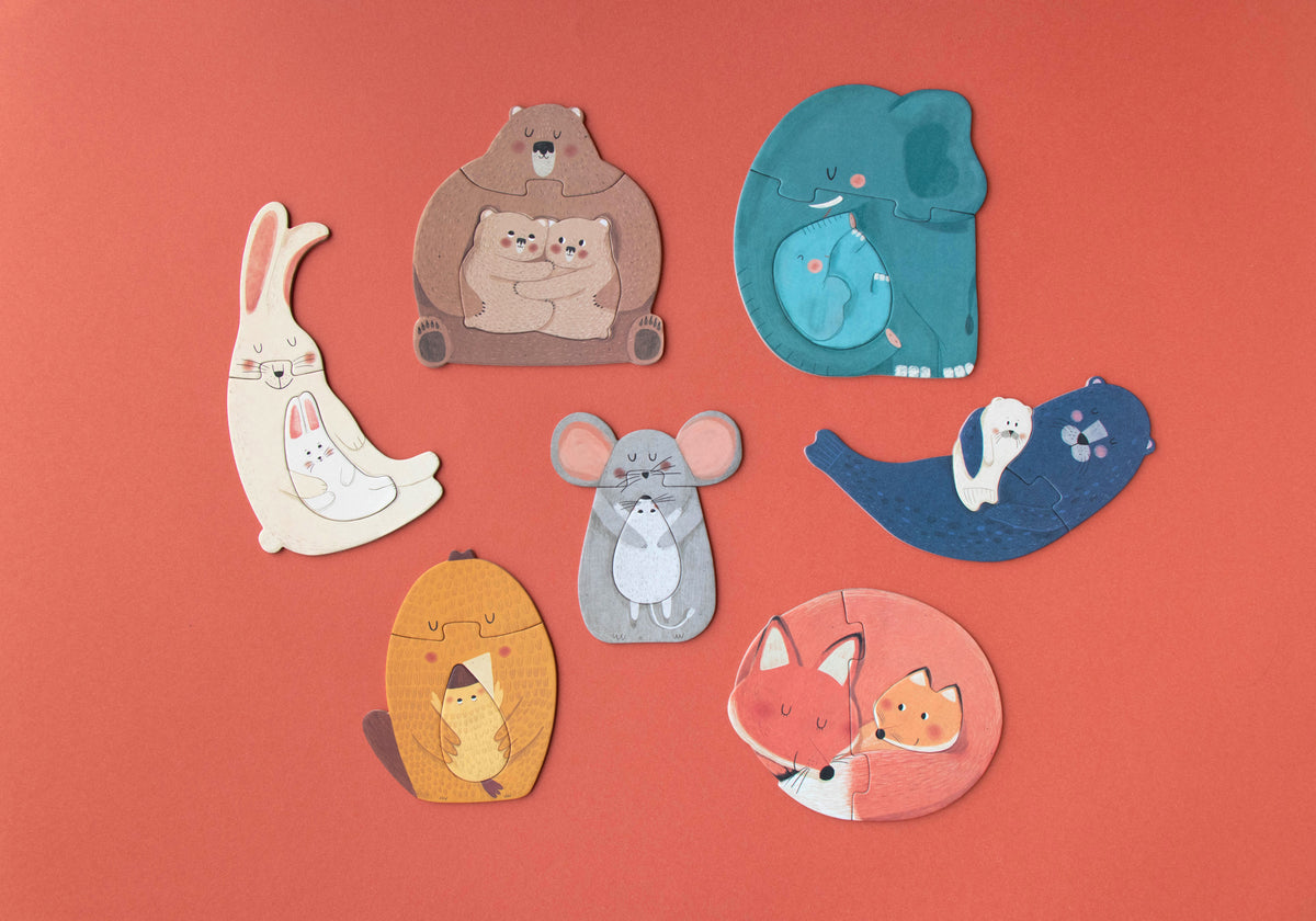 Set of animal-shaped pins on a red background