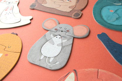 Collection of animal-shaped coasters on a pink surface