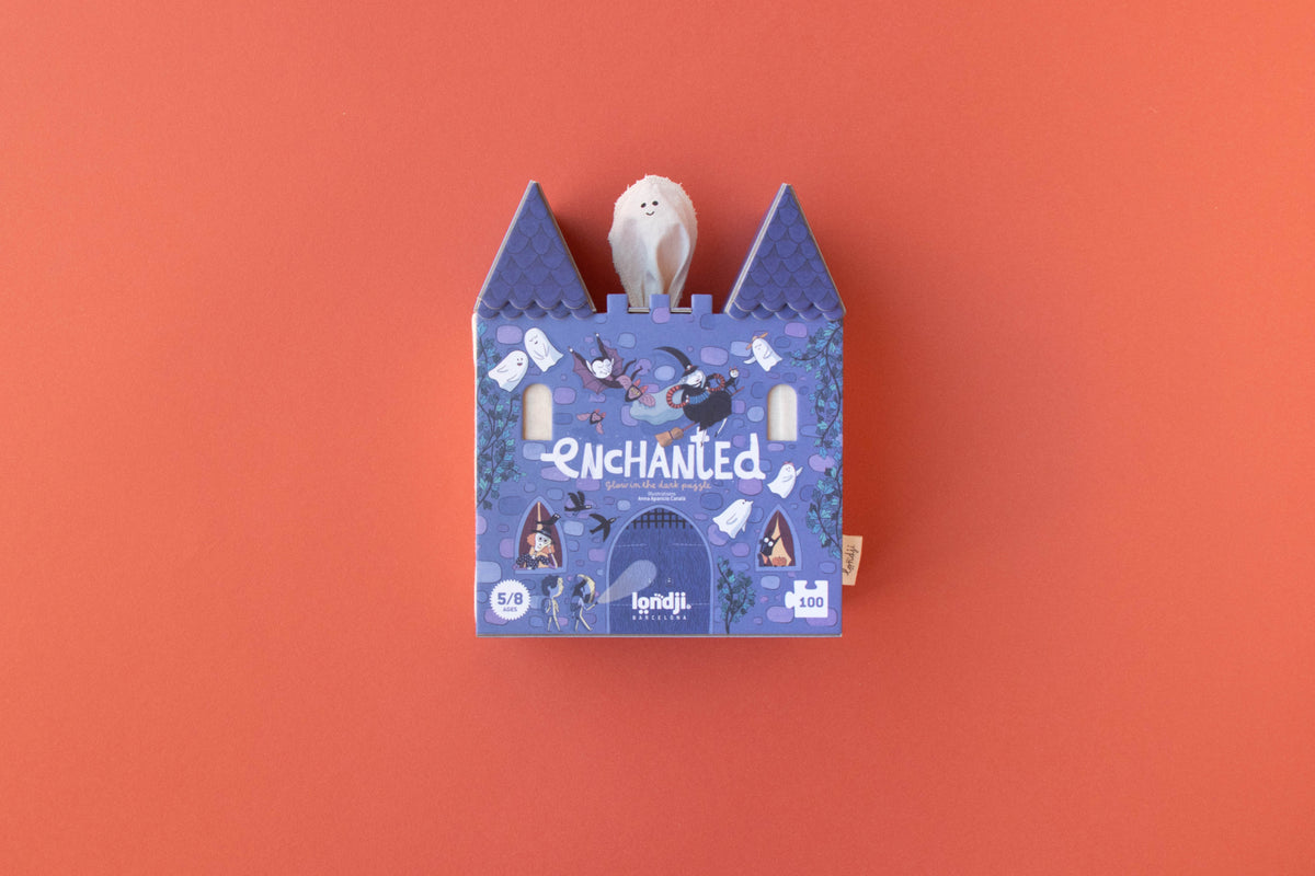 Blue castle-shaped box with a white plush toy on an orange background