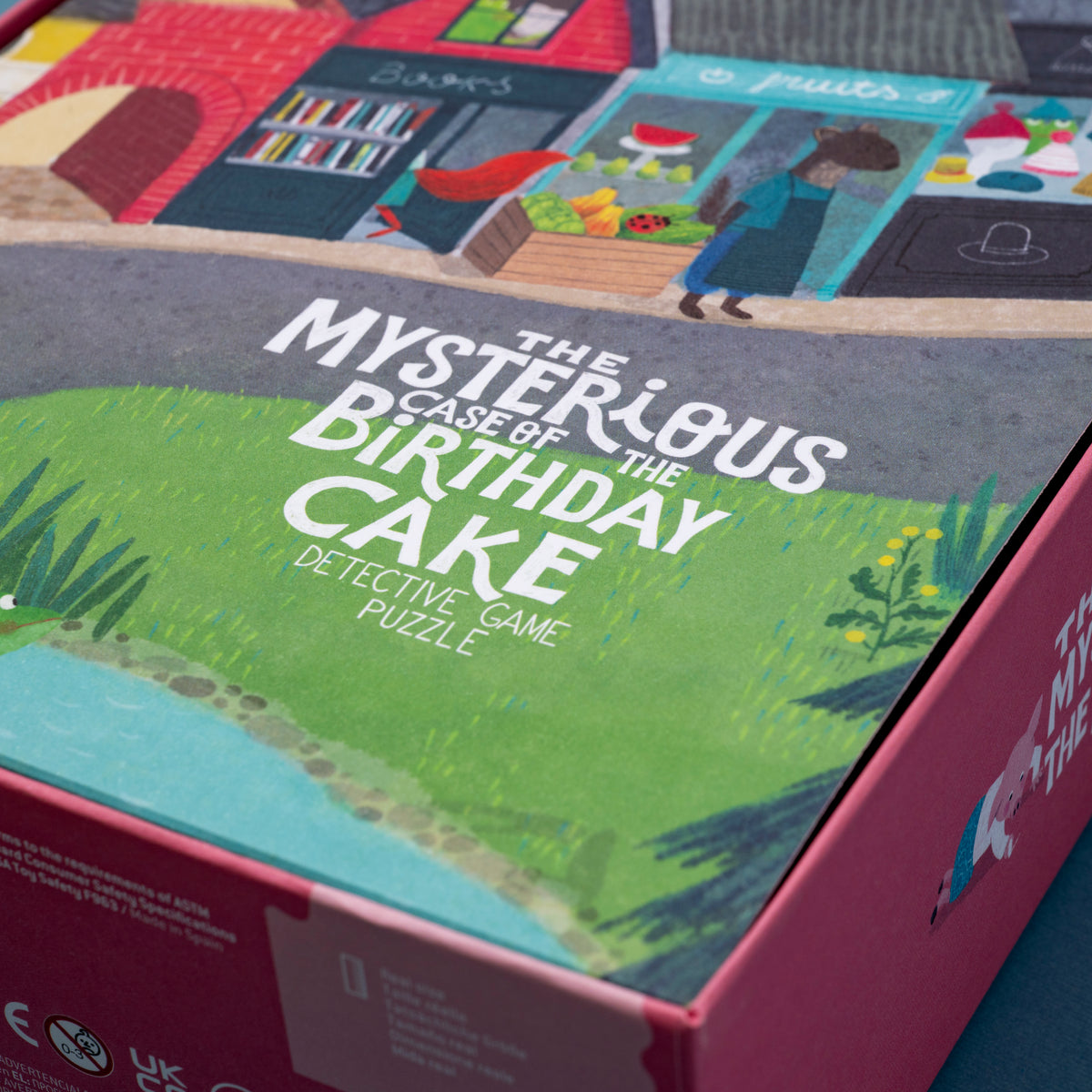 Box of 'The Mysterious Case of the Birthday Cake' detective game puzzle with colorful illustrations.