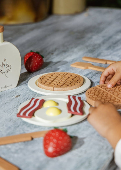 Wooden brunch playset pieces arranged for pretend cooking