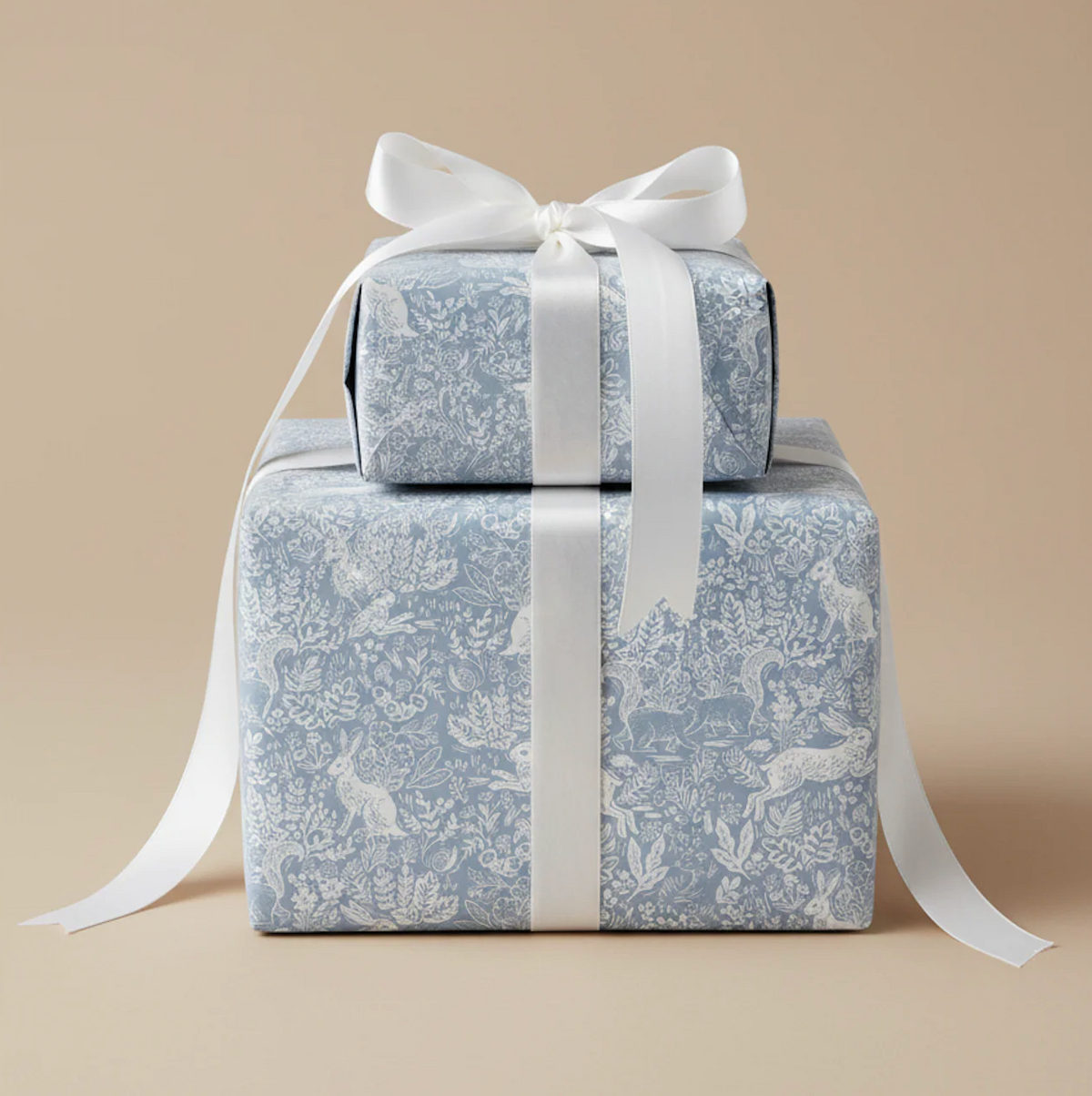 Gifts wrapped in patterned paper and tied with a white satin ribbon