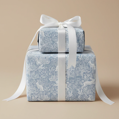 Gifts wrapped in patterned paper and tied with a white satin ribbon