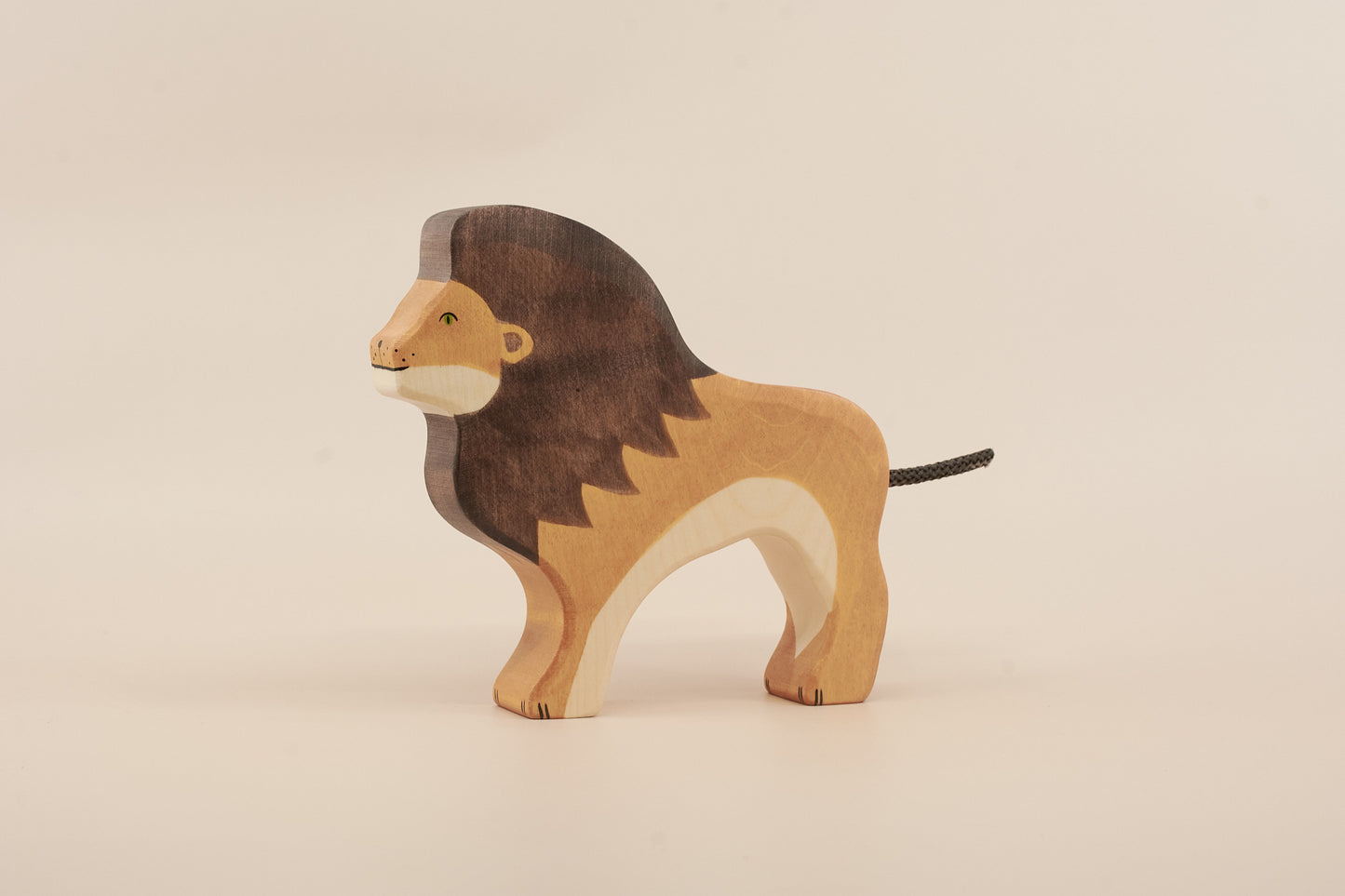 Wooden lion toy on a beige background