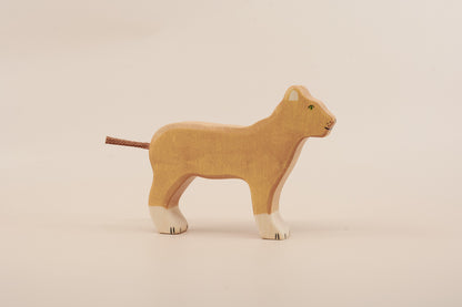 Wooden lion toy on a beige background