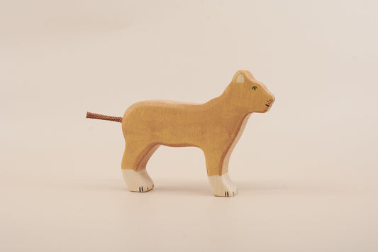 Wooden lion toy on a beige background