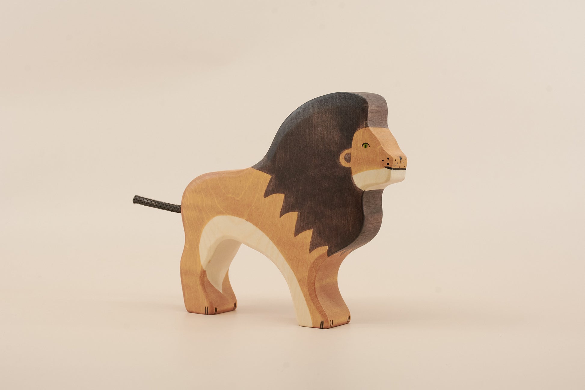 Wooden lion toy on a beige background