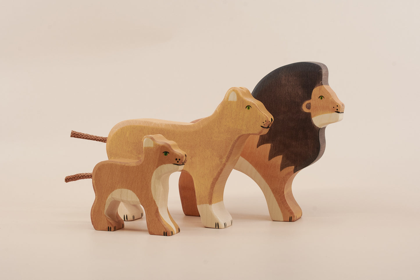 Handcrafted wooden lion family figures made from natural maple and beech wood
